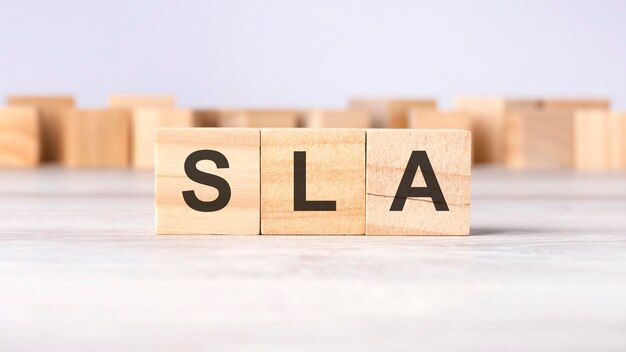 Photo sla word concept written on wooden cubes or blocks on a light background