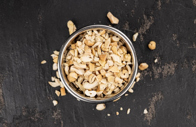 Slate slab with chopped Cashew nuts closeup shots selective focus