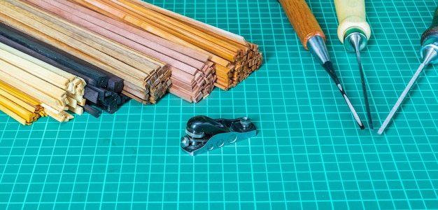 Slats of different types of wood and a tool for wooden ship modeling