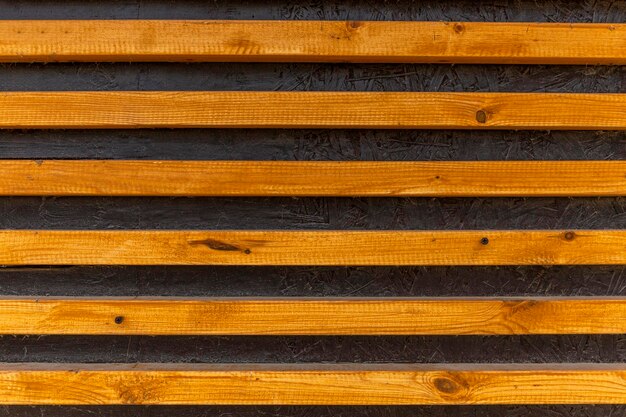 Slatted wooden surface with horizontal stripes Closeup Construction renovation and interior design