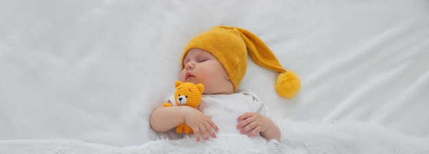 Sleeping child in bed holding teddy bear Selective focus