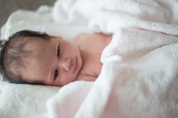 sleeping newborn baby in a wrap