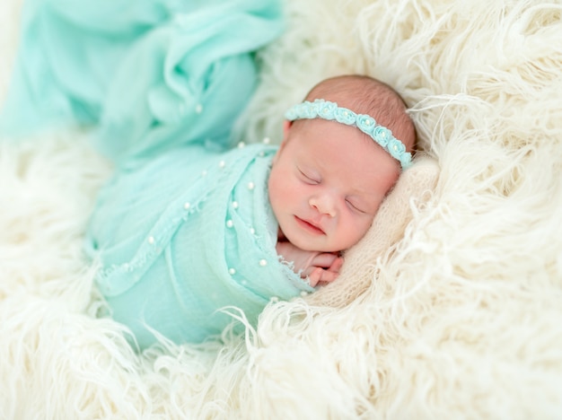 Sleeping newborn in blue headband