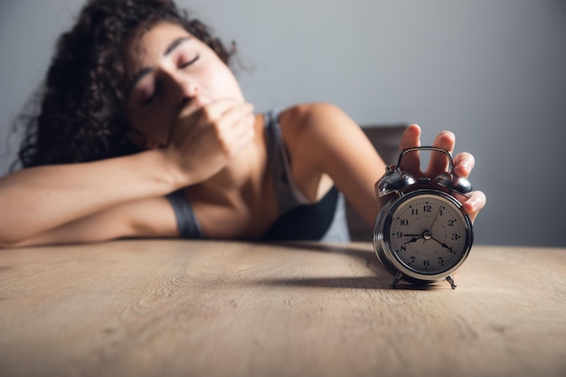 Sleepy woman hand clock