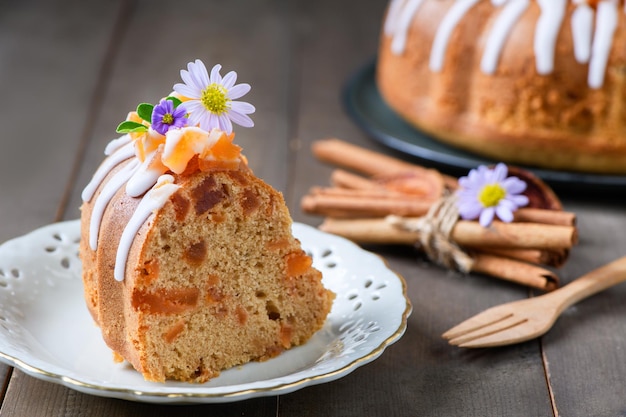 Slice of Bael Fruit Cake decorated with small flowers on top sweet and healthy dessert homemade cake