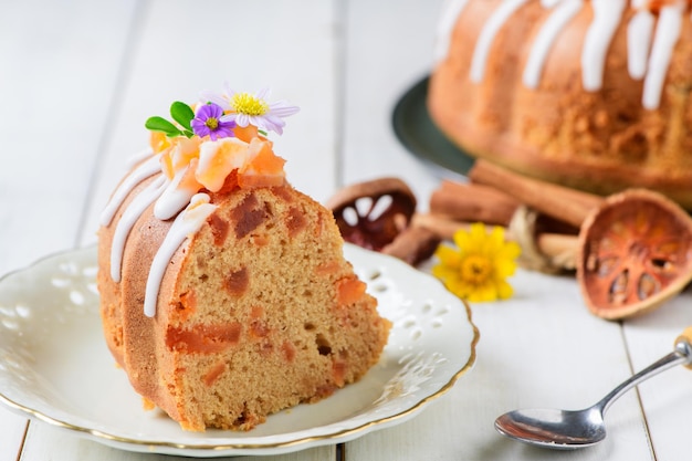 Slice of Bael Fruit Cake decorated with small flowers on top sweet and healthy dessert