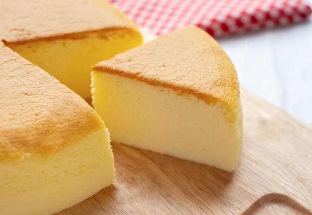 Slice of butter cake on wooden background