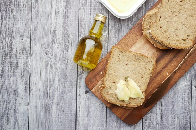 Slice of butter and whole meal bread on chopping board