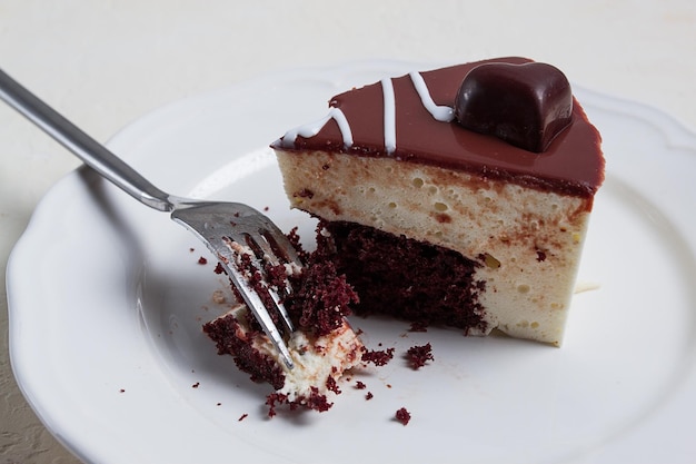 Slice of cake bird39s milk chocolate sponge cake with souffle sweet dessert on a white plate closeup horizontal no people