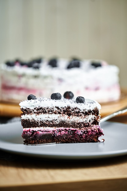 Slice of cake with berries on plate.