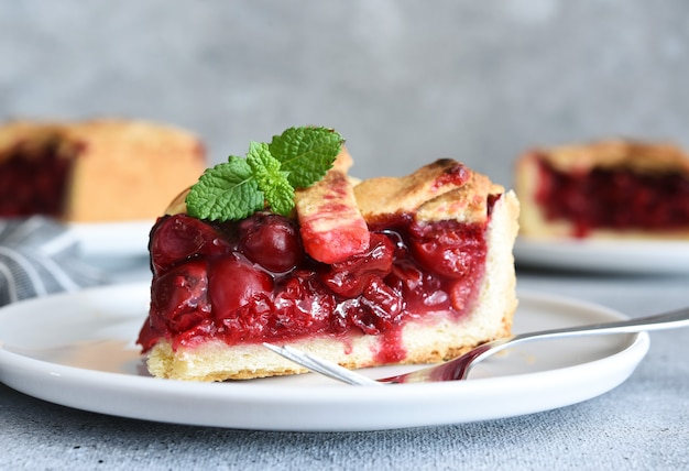 Slice of cherry pie on the kitchen table. Fruit pie. Tart.