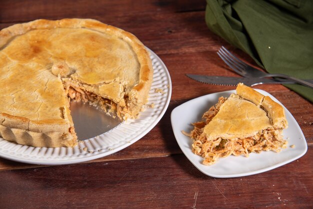 slice of chicken pie on rustic wooden background