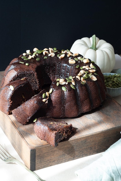 A slice of chocolate cake with a pumpkin on the side.