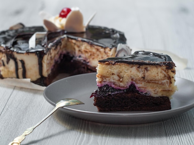 Slice of delicious chocolate cake filled with currant jam