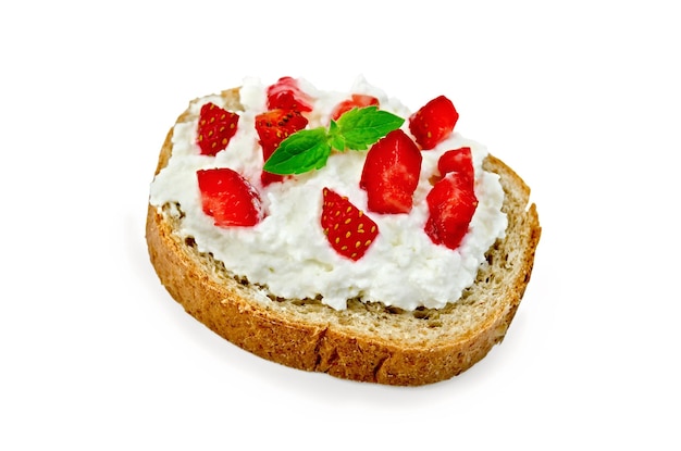 Slice of french bread with curd cream, strawberry and mint isolated on white background