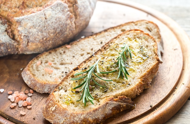 Slice of fresh bread with olive oil and herbs