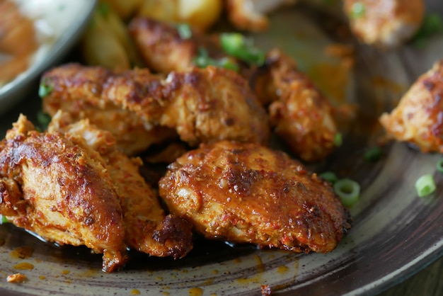 Slice of grill chicken on a plate on table