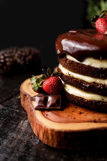 Slice of homemade chocolate cake with tasty strawberry on the table