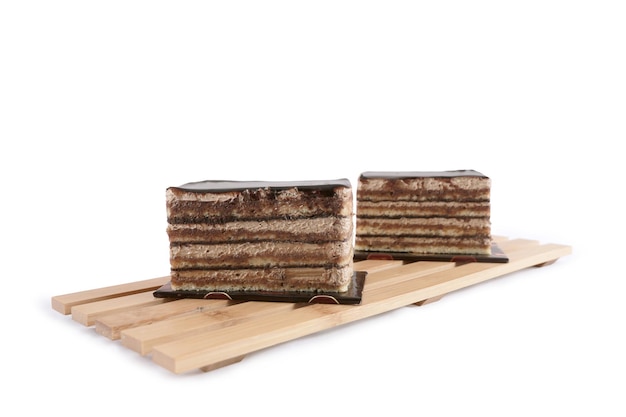 A slice of opera cake on white background