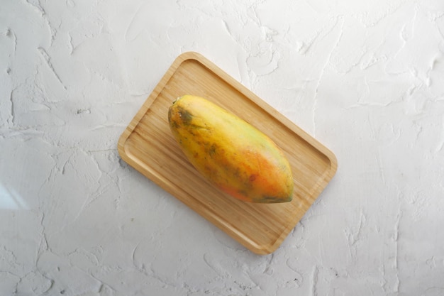 Slice of papaya on white plate