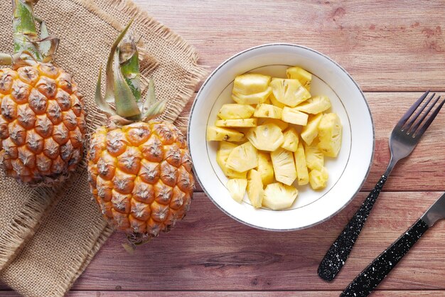 Slice of pineapple in bowl on table