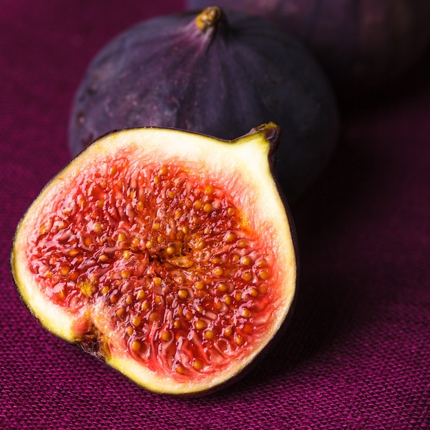 Slice of purple figs on background closeup