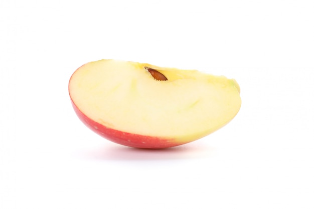 Slice of red apple on white table