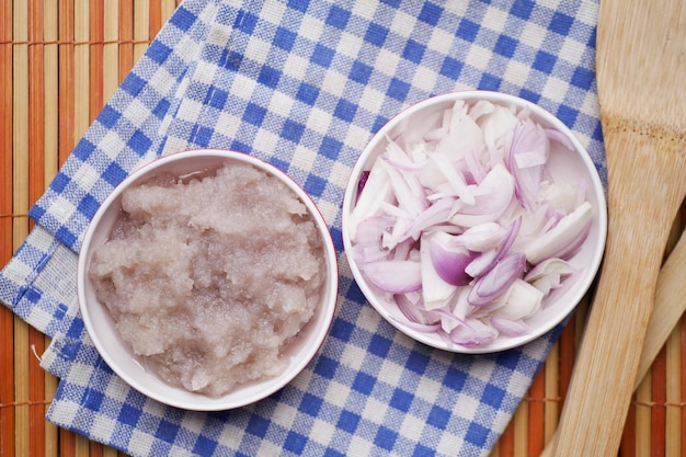 Slice of red onion and paste in a bowl on table