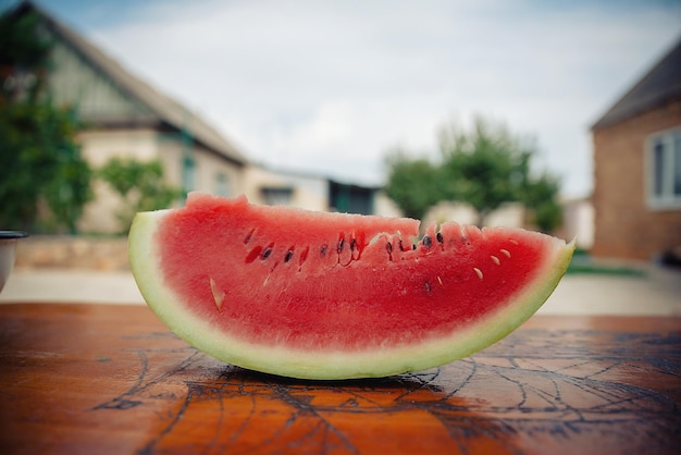 Slice of ripe red watermelon close-up on a blurred background. Delicious berry for children and adults