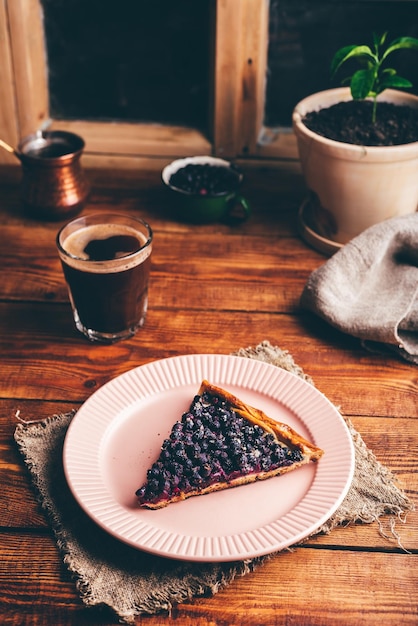 Slice of Serviceberry Pie on Plate and Glass of Turkish Coffee