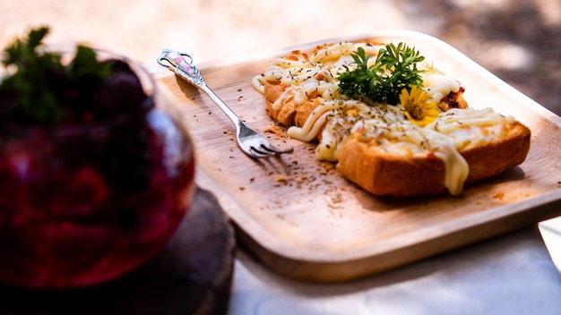 Slice of toasted white bread spread with mayonnaise decorate on top with flower and vegetable