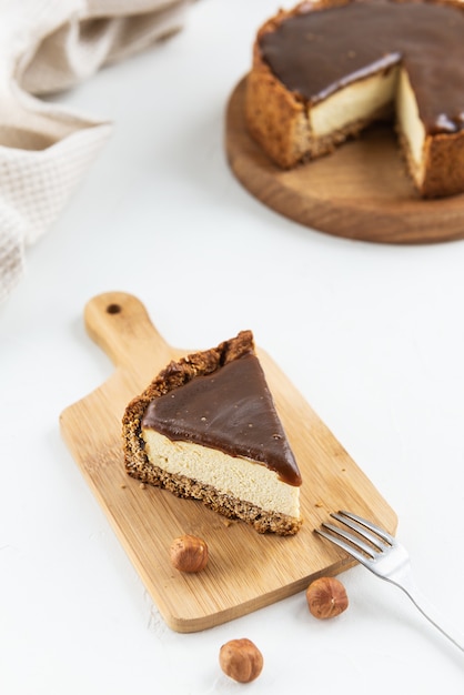 Slice of tofu cheesecake with coconut caramel on a wooden board