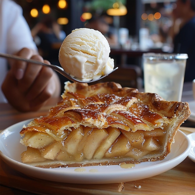 A slice of warm apple pie with a scoop of vanilla ice cream