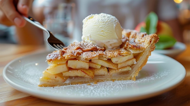 A slice of warm apple pie with a scoop of vanilla ice cream