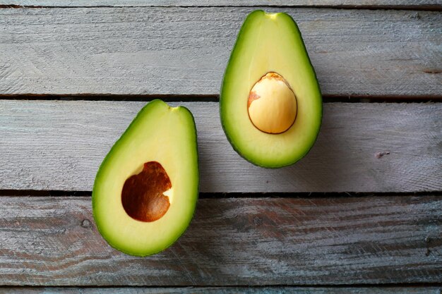 Sliced avocado on wooden background