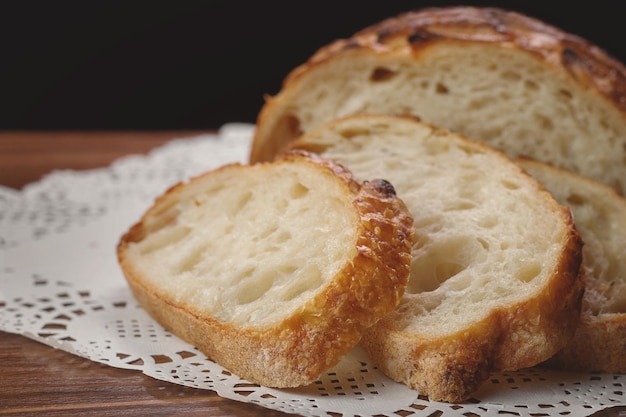 Sliced baked wheat bread on napkin on table selective focus