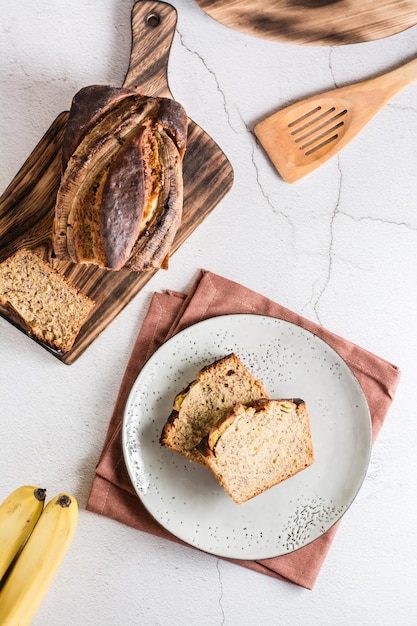 Sliced banana bread on a plate on the table Homemade trendy breakfast Top and vertical view