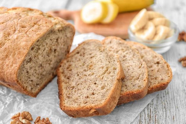 Sliced banana bread with nuts on wooden table