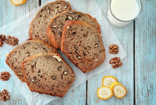 Sliced banana bread with nuts on wooden table