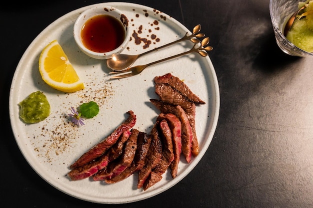 Sliced beef steak on black plateFood concept background