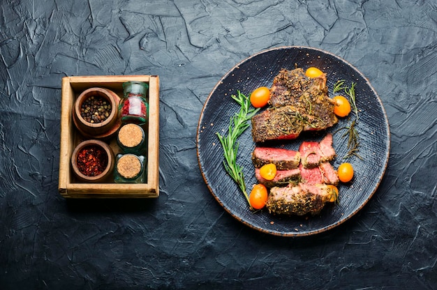 Sliced beef steak roasted with kumquat,rosemary and spices