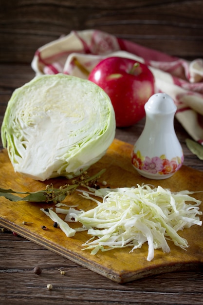 Sliced cabbage on old wooden board