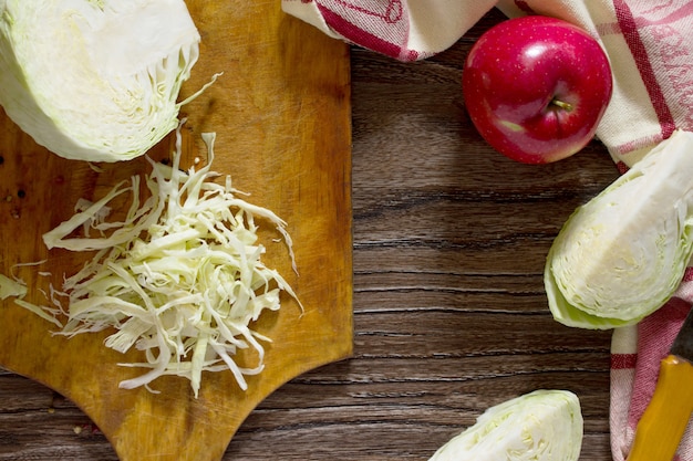 Sliced cabbage on old wooden board