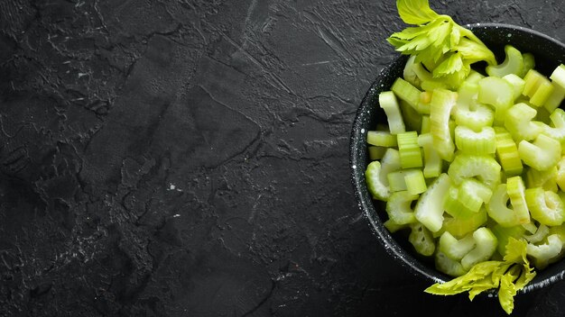 Sliced celery stalk On a black background Healthy food Top view Free space for your text