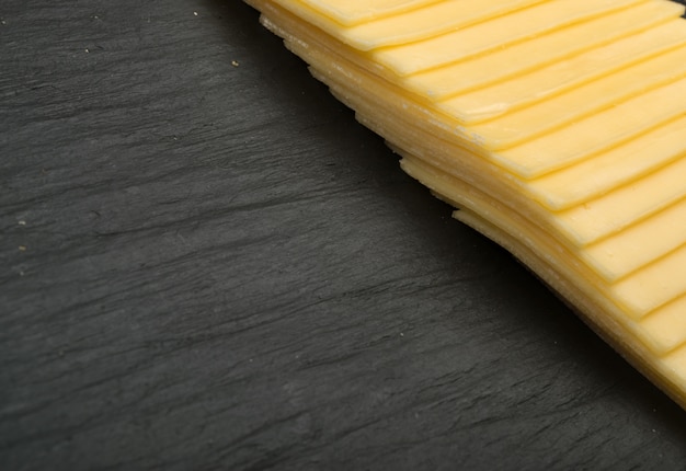 Sliced Cheese Over Stone Background