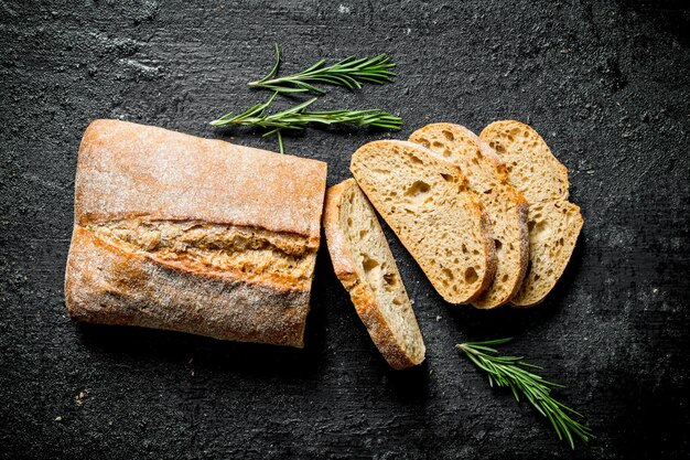 Photo sliced ciabatta bread with rosemary