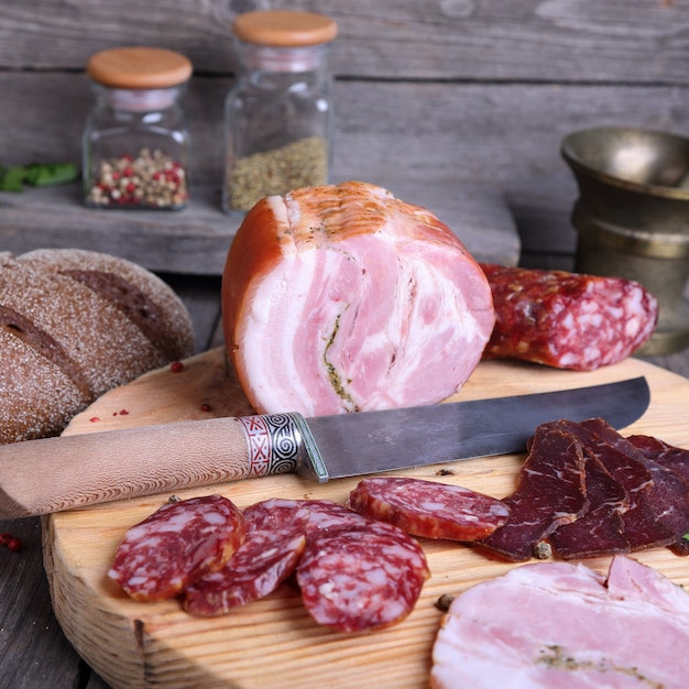 Sliced cold meats on a cutting board square photo