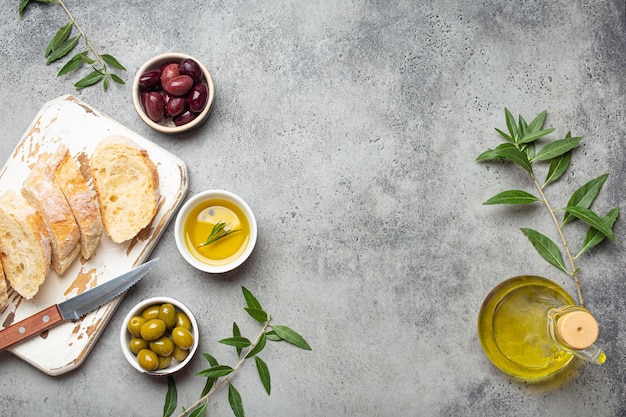 Sliced fresh ciabatta on cutting kitchen board green and