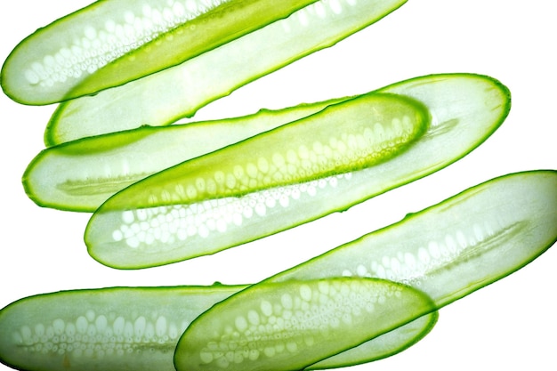 Sliced fresh green cucumber isolated on white background Long transparent stripes Top view with copy space for text Flat lay