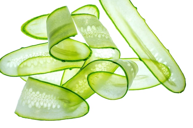 Sliced fresh green cucumber isolated on white background Long transparent stripes Top view with copy space for text Flat lay